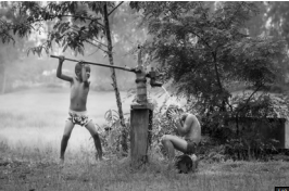 Black-and-white photo of two children showering — raw visual input